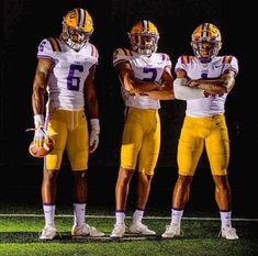 three football players are standing on the field