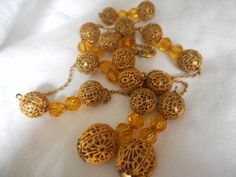 "Here we have a vintage pierced gold metal ball bead and faceted glass bead tassel necklace. This is 18\" with a 2 1/2\" tassel(longest one). Beads are about 10mm and bottom 2 about 12mm. These are a vintage item, please look at pictures. PLEASE convo me with any questions. Please check out my other items. Thanks for looking Elvira" Vintage Style Dangling Beads For Gift, Antique Large Gold Beads, Antique Gold Beaded Necklaces With Large Beads, Vintage Gold Beads For Party, Vintage Large Gold Beads, Victorian Style Gold Beaded Necklace, Vintage Gold Beaded Necklaces With Faceted Beads, Vintage Gold Beads For Gifts, Vintage Gold Beaded Necklace With Faceted Beads