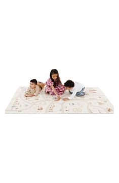 three children playing on a play mat with an adult and child in the middle one laying down