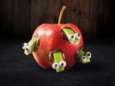 an apple with googly eyes and one eye on it