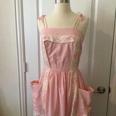 Vintage 60s Pink And White Gingham Dress. Thick Organza-Like Trim /Apron Detail. Fit And Flare Style With Gathered Skirt. Zips Up Center Back With A Nylon Zipper. Has Small Hole In Fabric On Front Bodice, See Pic. It Is Small And Is 1.75” Above Waistline. A Thick Belt Can Hide This. Zipper Has Some Loose Stitching, Looks Like It Was Redone At Some Point, It Can Benefit From Some Extra Stitches That I Have Not Done. Top Bodice Is Fully Lined With Same Gingham Fabric. Very Good Condition And Freshly Laundered! Measurements Bust 32-32.5” Side Seam To Side Seam Length 31.5” Top Side Seam To Hem Shoulder Straps Tie At Top Of Shoulder.. Spring Retro Gingham Dress, Fitted Gingham Retro Vintage Dress, Retro Fitted Gingham Vintage Dress, Vintage Gingham Dresses With Square Neck, Fitted Gingham Vintage Dress, Fitted Vintage Gingham Dress In Retro Style, Retro Square Neck Dress For Picnic, Vintage Gingham Dress For Spring, Gingham Vintage Dress For Spring