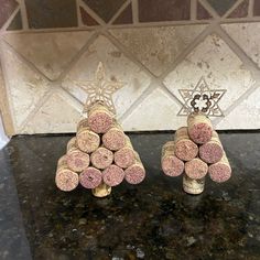 two wine corks are stacked on top of each other in the shape of a christmas tree