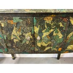 an old green and yellow painted cabinet