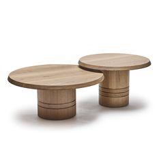 two wooden tables sitting next to each other on top of a white surface with no one around them