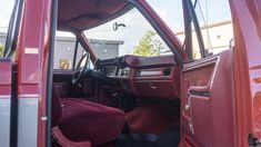 the interior of a red truck with its door open