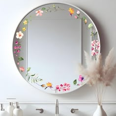 there is a mirror with flowers painted on it