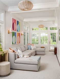 a living room filled with furniture and lots of windows