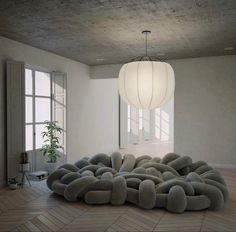 a large bean bag chair sitting on top of a hard wood floor in an empty room