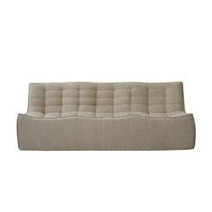 a beige couch sitting on top of a white floor