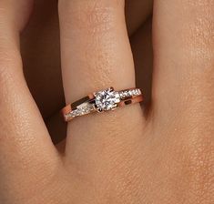 a woman's hand with a diamond ring on her left and an engagement band on her right