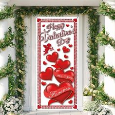 a valentine's day door with hearts on it and greenery around the doors