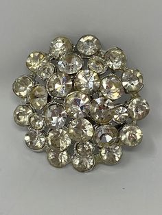 A beautiful, unsigned Dome Clear Rhinestone Brooch  Preowned  Diameter 1.25 inches  Very good condition  Lovely Shine, heavy, would make a great addition to any outfit or collection  Locking C clasp and bar in working order  Silver tone findings  Thank you for stopping by my shop. Vintage Crystal Brooches For Anniversary, Vintage Anniversary Brooch With Sparkling Stones, Vintage Bling Brooches For Anniversary, Wedding Brooches, Festival Scarves, Silk Bracelet, Vintage Rhinestone Brooch, Hippie Bracelets, Wedding Brooch