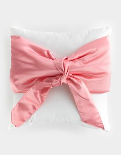 a pillow with a pink bow on it