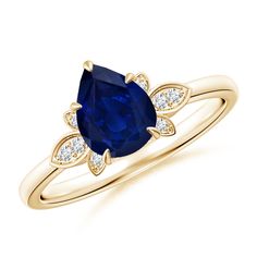 a yellow gold ring with an oval blue sapphire and diamonds