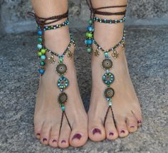 This listing is for a PAIR of barefoot sandals. Beautiful and unique barefoot sandals with a tribal vibration. They look great as necklace or on the hands too :) Handmade crocheted with love and care using waxed polyester cord, brass flowers and charms and blue and green glass beads. The lace is long enough to wrap it 2 times around the leg. Each end of the string is closed with acai seed beads and a brass bead cap. These resistant sandals are suitable for many environments. They will embellish Hippie Summer Festival Jewelry, Summer Festival Beaded Anklets, Bohemian Toe Ring Jewelry For Summer, Handmade Ankle Wrap Anklets For Festivals, Spiritual Anklets For Summer Beach Season, Adjustable Spiritual Anklets For Summer, Spiritual Summer Beach Anklets, Handmade Toe Ring Barefoot Sandals For Summer, Summer Beaded Barefoot Sandals As Gift