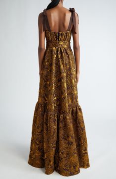 Make an unforgettable entrance at your next gala event in this opulent gown crafted of shimmering crinkled brocade patterned in a stunning sunflower motif. A structured bodice with grosgrain-ribbon straps and beaded brooches balances the full flounced-hem skirt that's completed with handy pockets. 61" length (size 6) Hidden back-zip closure Square neck Adjustable tie straps Side-seam pockets Lined 68% nylon, 21% polyester, 11% elastane Dry clean Made in the USA Designer Clothing Rose Formal, Gold Brocade Dress, Brocade Gown, Sunflower Motif, Gala Event, Beaded Brooches, Gold Brocade, Gala Events, Brocade Dresses