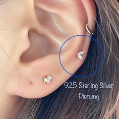 an ear with two piercings attached to it and the words 925 sterling silver piercing