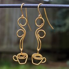 These beautiful, handcrafted coffee earrings are wire wrapped out of high quality non-tarnish coated copper wire and are perfect for coffee lovers!SHIPPING: Rings are shipped inside a cotton filled box (all ready for gift giving) and the box inside a bubble package.WIRE COLORS: Gold, Silver, Rose Gold, Vintage Bronze and Antique Copper.IMPORTANT: All rings are created by hand just for you, so your ring may not look EXACTLY like the picture.Handmade itemMaterials: CopperMade to orderLength: 7.5 H Coffee Earrings, Diy Wire Jewelry Rings, Coffee Earring, Wire Jewelry Earrings, Wire Jewelry Rings, Wire Wrapped Jewelry Diy, Wire Jewelry Designs, Earrings Wire, Diy Wire Jewelry