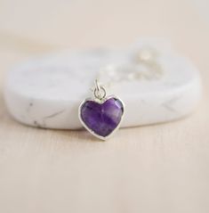 Give yourself some love or show your love for that special someone in your life with this heart necklace!Amethyst is believed to carry the energies of passion, creativity, and spirituality. It's also said to assist with temperance and sobriety, as well as inflammation.This necklace is handcrafted with a purple Amethyst faceted heart pendant. Each stone is natural and therefore contains natural inclusions or crystal formations. They are edged in 24k gold or silver electroplate. STONE SIZE: averag