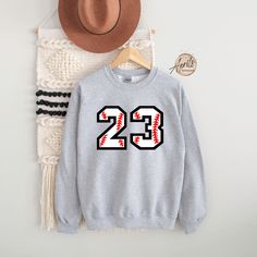 Custom Baseball Number Sweatshirt or Hoodie, Baseball Sweatshirt, Baseball Hoodie, Personalized Hoodie, Custom Sweatshirt, Softball Hoodie CAUTION: For security reasons, there is no rope in the throat area for youth hoodie. Hello!! Dear Customer, We're here to give you best Custom Sport  sweatshirt, hoodie and crewneck options for you. We want to make everyone smile with our cute , stylish and trendy graphic T-shirts. We can assured you this shirt will be perfect Custom Sport sweatshirt, hoodie Fall Season Sportswear Sweatshirt For Fan Gear, Sports Fan Long Sleeve Hoodie, Sports Fan Long Sleeve Hoodie For Streetwear, Team Spirit Hoodie For Sports Season, Fleece Sportswear Hoodie, Winter Long Sleeve Sports Fan Hoodie, Sportswear Fleece Hoodie With Crew Neck, Fleece Sportswear Sweatshirt For Fan Gear, Varsity Hoodie Fan Gear Top