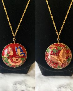 Vintage red floral butterfly reversible cloisonné enamel round puffy pendant on 18K gold plated wave chain. Each side is a different design! The head pin and jump ring are 18K gold plated. Necklace drop length of about 22-23 cm as the default chain. Comes in a box. Please keep in mind that the pendant itself is vintage so it may show some signs of age/wear which includes any signs of chipping or tarnishing. If you need a chain of another length, please select in the menu. If you need a chain len Red Enamel Round Necklace, Red Enamel Round Pendant Necklace, Gold Hand-painted Round Pendant Necklace, Vintage Red Hand Painted Jewelry, Red Hand Painted Pendant Necklaces, Red Enamel Jewelry With Large Pendant, Unique Red Enamel Necklaces, Red Butterfly-shaped Jewelry Gift, Red Butterfly Jewelry For Gift