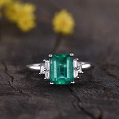 Vintage Emerald Ring Emerald Engagement Ring Promise Bridal Wedding Ring,Vintage Engagement Ring,Art Deco engagement ring,unique engagement ring,Halo Diamond engagement ring 7x5mm emerald engagement ring with one baguette cut diamond on each side: https://www.etsy.com/listing/864918653/natural-emerald-engagement-ringthree ITEM DESCRIPTION Main ring: ✦8x6mm Emerald Cut Natural Emerald (with a certificate) ✦0.38ctw round cut Natural SI/H Diamonds or moissanite stones Band width approx 2mm Prong se Wedding Emerald Ring With Center Stone And Baguette Cut, Classic Emerald Ring With Baguette Diamonds For Anniversary, Classic Emerald Ring With Baguette Diamonds For Wedding, Vintage Wedding Diamond Ring With Baguette Diamonds, Vintage Diamond Ring With Baguette Diamonds For Wedding, Heirloom Baguette Cut Emerald Ring For Wedding, Heirloom Baguette Cut Emerald Wedding Ring, Emerald Ring With Baguette Diamonds For Wedding, Fine Jewelry Emerald Ring With Baguette Diamonds For Anniversary