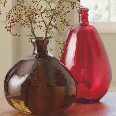 two vases sitting on top of a wooden table