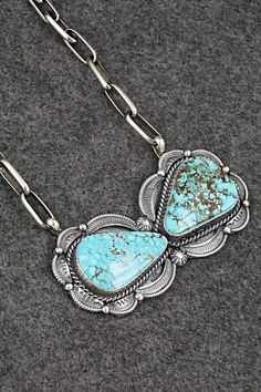 This stunning natural Kingman turquoise and sterling silver necklace was made by Navajo silversmith Raymond Delgarito. The back is signed RD and stamped sterling. Necklace: 20" with additional 3 1/2" extender chain Pendant Length: 1 3/8" Pendant Width: 3 1/8" Free shipping on all orders! We ship with USPS and always include tracking. All orders ship within a day of payment. Returns are accepted up to 30 days after you receive your order. Just send us a message. Our shop offers cash back or store credit. The item must be returned in new condition. Western Sterling Silver Turquoise Necklace, Western Style Sterling Silver Turquoise Necklace, Western Style Collectible Turquoise Sterling Silver Necklace, Southwestern Sterling Silver Turquoise Necklace, Western Style Sterling Silver Necklace With Large Pendant, Western Style Necklace With Large Sterling Silver Pendant, Southwestern Turquoise Sterling Silver Collectible Necklace, Southwestern Sterling Silver Turquoise Necklace Collectible, Sterling Necklace