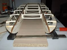 several wooden boats are being made on a table