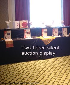 two - tiered silent auction display in front of a window