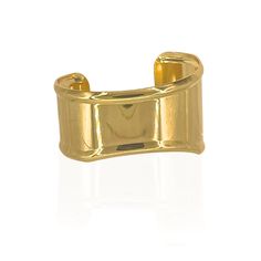 Gold-plated over brass. Adjustable statement cuff. Classic Gold-tone Metal Cuff Bracelet, Gold Polished Cuff Bracelet, Gold Polished Open Cuff Bracelet, Timeless Gold Open Cuff Bracelet, Classic Brass Cuff Bracelet For Formal Occasions, Metal Cuff Bracelet With Polished Finish, Polished Metal Cuff Bracelet, Gold Wide Band Metal Cuff Bracelet, Chic Gold Cuff Bracelet With Polished Finish