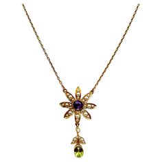 This stunning floral pendant necklace is modern but also classic vintage. The necklace is from the early 1900's and replicates a beautiful flower with petals adorned in tiny seed pearls. The center is a round faceted amethyst and the bottom petal has a drop of seed pearls accenting an oval faceted peridot. The necklace is 16 inches long so it rests beautifully on your collarbone. Gorgeous! Luxury Antique Flower Pendant Necklace, Luxury Victorian Flower Pendant Necklace, Floral Pendant Necklace, A Beautiful Flower, Floral Pendant, Flower Pendant Necklace, Seed Pearl, Gold Flowers, Flower Pendant