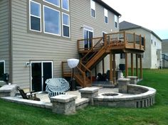 an outdoor patio with fire pit and stairs