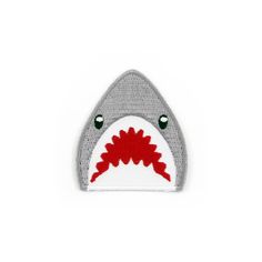 a shark shaped patch with red and white teeth