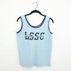 "Great vintage LSSC tank top. As you can see from the photo it shows signs of age and wear but is in great condition. Size: tagged Medium All measurements taken with garment laid flat. Please take the time to carefully read the measurements, there are no returns due to poor fit. Chest (pit to pit): 18\" Shoulder to shoulder: 13\" Sleeve length: N/A Length (down middle of back): 20\" Material: 100% Cotton Label: Collegiate Pacific Please message me with any questions or for more photos. And to see more items from my shop please visit:  http://www.etsy.com/shop/anystore" 90s Style Blue Sleeveless Tops, Vintage Washed Blue Relaxed Fit Top, Retro Blue Sleeveless Top, Blue Relaxed Fit Tank Top, Vintage Blue Sleeveless Top, Blue Graphic Tank Top For Sports, 90s Sleeveless Cotton Tank Top, Military Cap, Cotton Labels