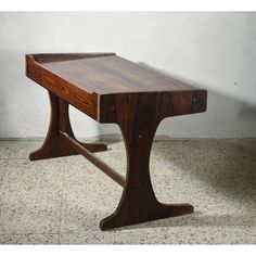 a wooden table sitting on top of a tiled floor