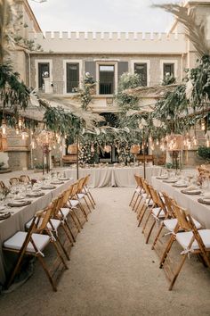 an outdoor venue with tables and chairs set up for a formal function in the courtyard