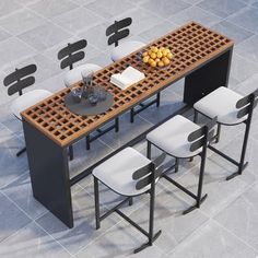 a dining table with four chairs around it on the tile floor, surrounded by black and white tiles