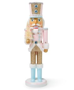 a nutcracker figurine holding a christmas tree