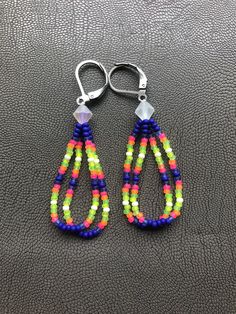 Handmade earrings. Native American beaded earrings made with size 11 seed beads Colors are super bright matte neons pink, orange, green, yellow, white and blue made with a clear matte AB bicone bead topper They measure about 1.5 inches long with a stainless steel leverback hooks. I now offer free shipping on orders $35.00 and over! Handmade Neon Jewelry For The Beach, Beautiful Beaded Earring, Earrings Native American, Beads Colors, Native American Beaded Earrings, Jewelry Making Project, Native American Beading, Bead Earrings, Aurora Borealis