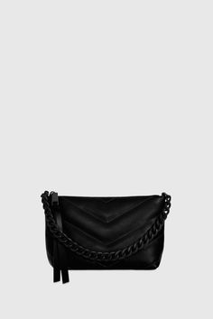 The Edie Maxi Quilt Crossbody With Chain is compact yet bold, featuring quilted detailing and a chain strap that elevates its luxe appeal. This versatile piece transitions effortlessly from day to night, offering sleek style with functional storage. Style # CH24MEQXBO-BLACK 100% Smooth Leather Black Shellac Hardware 9. 25" W X 6. 5" H X 3. 75" D 20. 5" Strap Drop 7. 5" Handle Drop 1 Zip Pocket Black Cotton Twill Lining Imported The photos featuring a model are for size reference only. Actual color and material may vary from what is depicted. | Rebecca Minkoff Edie Maxi Quilt Crossbody With Chain Bag In Black Black Shellac, Leather Outerwear, Womens Designer Handbags, Handbags Designer, Suede Fashion, Chevron Quilt, Sleek Style, Functional Storage, Leather Dresses