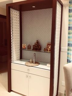 a white cabinet with some small items on it's top and side shelves in the middle