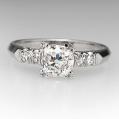 a diamond ring with three stones on the side