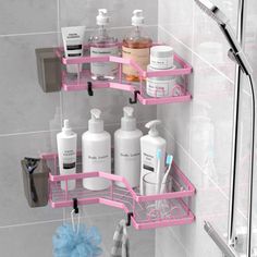 two pink shelves in the shower with soap, lotion and toothbrushes on them