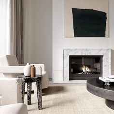 a living room with white furniture and a painting on the wall above the fire place