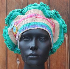 a mannequin head wearing a multicolored hat