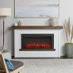 a living room with a fire place in the center and a painting on the wall