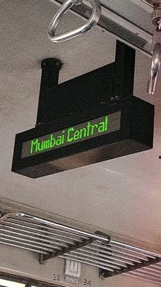 a sign that reads mumbai central hanging from the ceiling