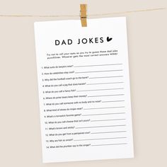 a card with the words dad jokes hanging on a clothes line next to a string