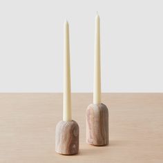 two candles sitting next to each other on a table